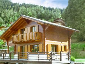 a log cabin with a balcony and a porch at Chalet L'Escapade by Interhome in Ovronnaz