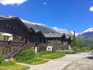 a group of buildings with mountains in the background at Apartment Aragon N103 by Interhome in Fiesch