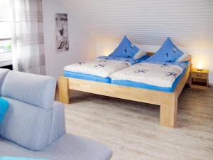 オッテルンドルフにあるApartment Gronau by Interhomeのベッドルーム1室(青い枕と椅子付きのベッド1台付)