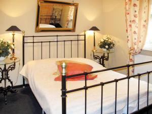 um quarto com uma cama com uma moldura preta e um espelho em Holiday Home Klipper by Interhome em Burhave