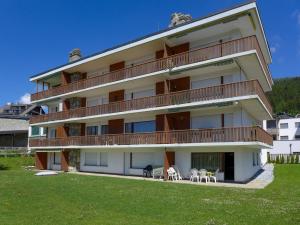 a large building with a balcony with tables and chairs at Apartment Andrea B15 by Interhome in Vermala