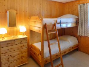 a bedroom with two bunk beds and a desk at Apartment Le Brévent 4 by Interhome in Villars-sur-Ollon