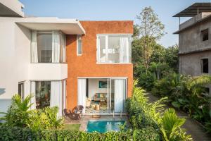 a house with a swimming pool in front of it at La Risa by The Blue Kite - 2 BHK Villas near Vagator Beach, Private Pool with Kitchen, Balcony, Security in Vagator