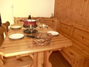オヴロナにあるApartment Tourbillon B 27 by Interhomeの木製テーブル(ワイングラス付)とバスケット