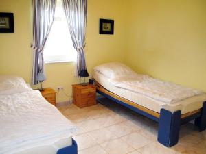 2 camas individuales en una habitación con ventana en Holiday Home Klipper by Interhome en Burhave