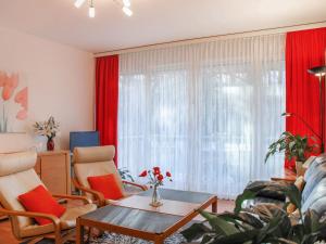 een woonkamer met rode gordijnen en een tafel bij Apartment Lido App- 46 by Interhome in Locarno
