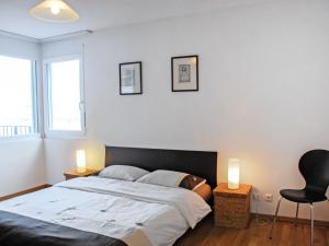 1 dormitorio con 1 cama y 2 velas en las mesas en Apartment Coris by Interhome, en Vira