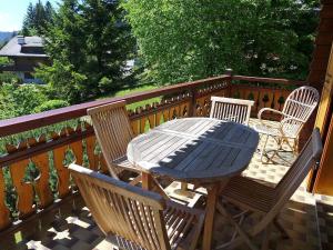 a table and chairs sitting on a deck at Apartment Sapin Bleu 5 by Interhome in Villars-sur-Ollon