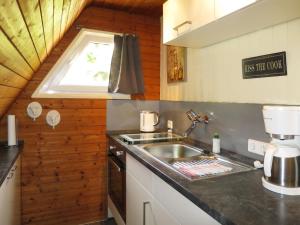 a kitchen with a sink and a window at Holiday Home Ferienhäusle Nina by Interhome in Wilhelmsdorf