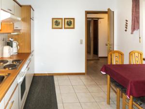 a kitchen with a table and chairs in a room at Apartment Janik by Interhome in Bischofsmais +16 photos