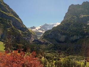 a view of a mountain valley with snow capped mountains at Apartment Chalet Bärgsunna-1 by Interhome in Grindelwald