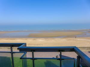 a blue picnic table in front of a beach at Apartment Isabelle-1 by Interhome in Cabourg
