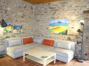 a living room with a couch and a table at Holiday Home Oleander - TDR100 by Interhome in Tordères