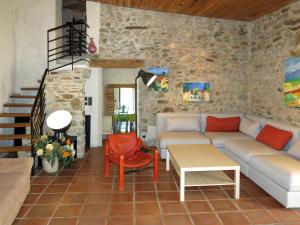 a living room with a couch and a table at Holiday Home Oleander by Interhome in Tordères