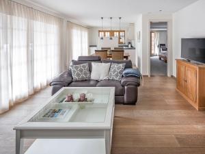 a living room with a couch and a table at Apartment Chalet Smaragd-1 by Interhome in Grindelwald