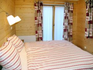 een kleine slaapkamer met een bed en een raam bij Apartment Fer à Cheval - CHL410 by Interhome in Châtel