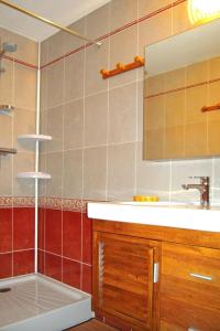 a bathroom with a sink and a shower with a mirror at Apartment Plagne Centre 3 - LAP173 by Interhome in La Plagne