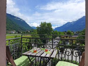 a table on a balcony with a view of mountains at Apartment Elegance by Interhome in Interlaken