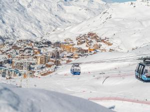 a ski resort with a town in the snow at Apartment Le Roc de Peclet by Interhome in Val Thorens