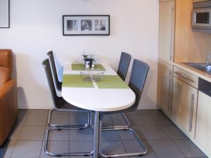 uma cozinha com mesa e cadeiras num quarto em Apartment Strandvilla - LUB111 by Interhome em Lubmin