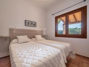 a bedroom with a large bed with a window at Holiday Home Morla by Interhome in Porreres