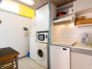 a small kitchen with a washer and dryer in it at Apartment Le Gallia by Interhome in Capbreton