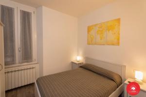 a bedroom with a bed and a map on the wall at Affittacamere Il Viaggiatore in La Spezia