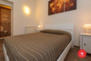 מיטה או מיטות בחדר ב-Affittacamere Il Viaggiatore