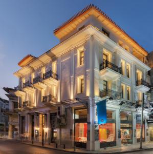 a large white building on the corner of a street at The Residence Aiolou Hotel & Spa in Athens