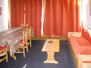 a classroom with a table and chairs and curtains at Apartment Plagne Centre 1 - LAP170 by Interhome in La Plagne