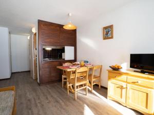 a living room with a table and a kitchen at Apartment Le Borsat - Val Claret-10 by Interhome in Tignes