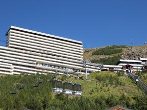 a large building with a ski lift in front of it at Apartment Brelin-8 by Interhome in Les Menuires