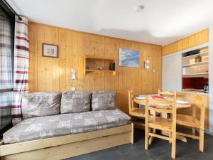 a room with a bed and a table in it at Apartment Les Soldanelles by Interhome in Les Menuires