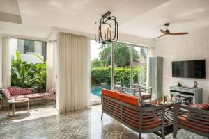 a living room with a couch and a table at La Risa Estate in Vagator