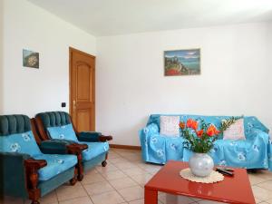 a living room with two blue couches and a table at Apartment Domenica - GRV150 by Interhome in Consiglio di Rumo