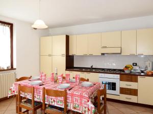 a kitchen with a table with a table cloth on it at Apartment Domenica - GRV150 by Interhome in Consiglio di Rumo