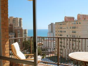a balcony with a table and chairs and a view of the city at Apartment Las Cinco Torres by Interhome in El Campello