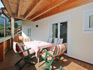 a patio with a table and chairs on a porch at Apartment Gerda-2 by Interhome in Ried im Zillertal