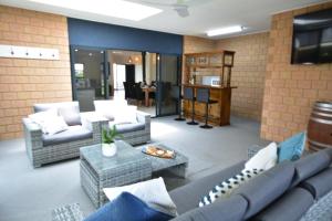 a living room with couches and a table at Stan Breeze: Elegant Family Retreat in Stansbury