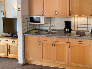 a kitchen with a sink and a microwave at Apartment Dehne-2 by Interhome in Norddeich