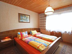 a bedroom with two beds and a window at Holiday Home Hussl by Interhome in Fügenberg +39 photos