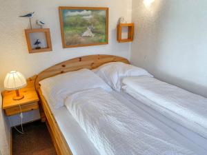 a bedroom with two beds and a table with a lamp at Apartment Dehne-2 by Interhome in Norddeich