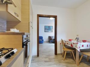 a kitchen with a table and a dining room at Apartment Bernard-1 by Interhome in Campestrin