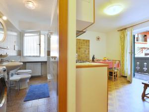 a kitchen and living room with a sink and a counter at Apartment Maura-2 by Interhome in Pozza di Fassa