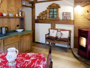 a kitchen with a table and a chair and a stove at Apartment La Tata by Interhome in Valtournenche