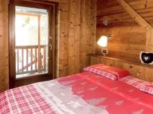 a bedroom with a bed in a wooden cabin at Apartment La Tata by Interhome in Valtournenche