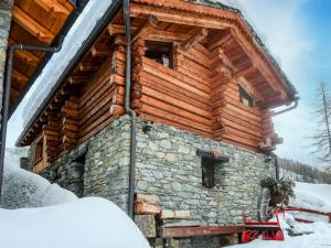 a log cabin in the winter with snow at Studio Ancienne Bergerie Studio 1 - VOU140 by Interhome in Valtournenche