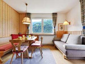 a living room with a couch and a table at Apartment Illyria by Interhome in Ortisei