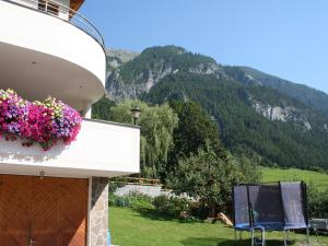 a balcony of a house with flowers on it at Apartment Christian by Interhome in Pettneu am Arlberg