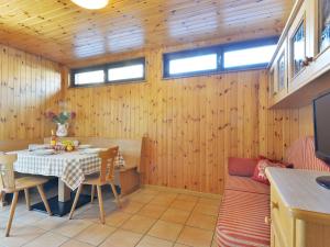 a dining room with a table and a couch at Apartment Cincelli - Marmolada by Interhome in Pozza di Fassa